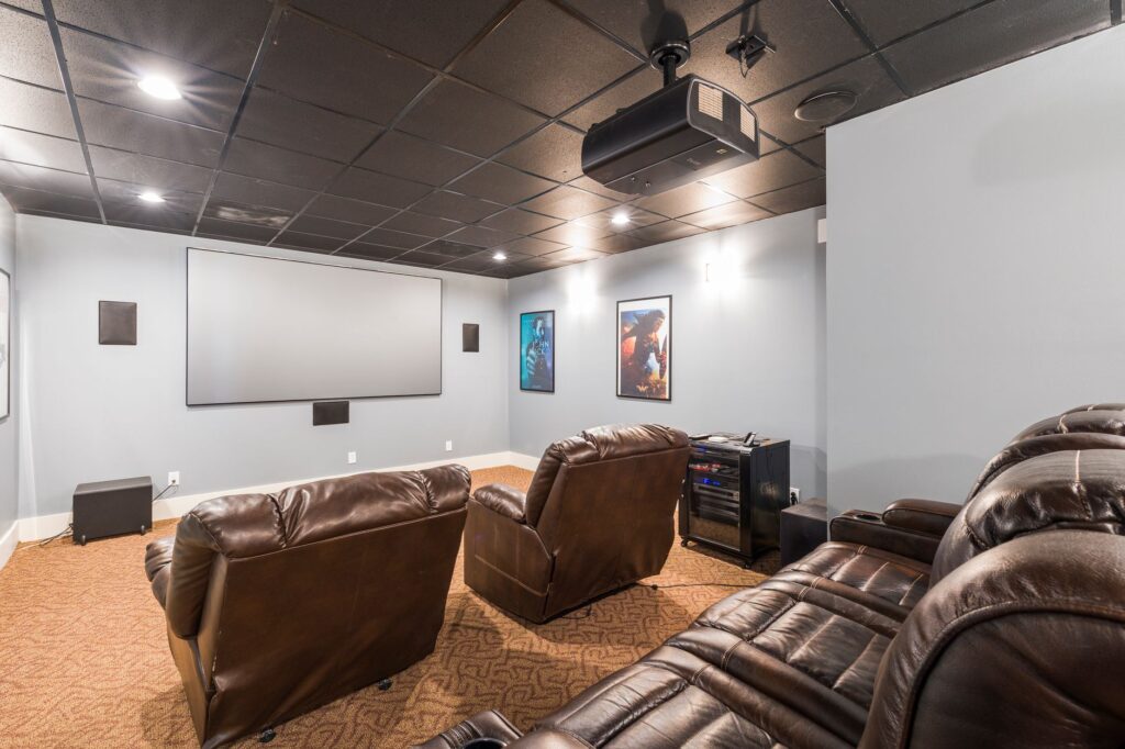 Luxury home theater media room with large screen and recliner seating